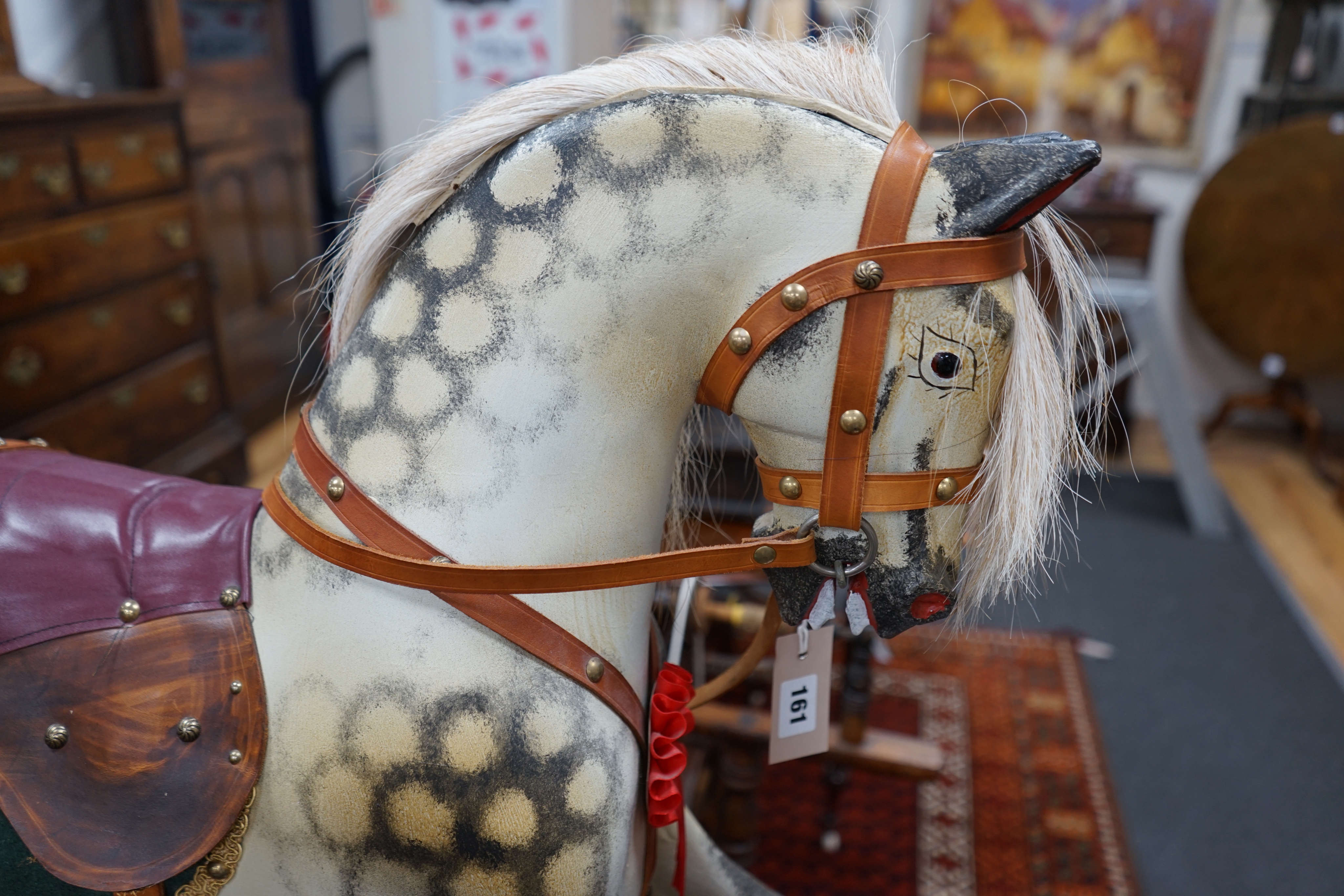 A small Ayres type dapple grey rocking horse, on safety frame, length 106cm height 96cm